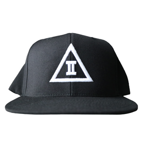 A black snapback hat with a 3D puff embroidered design on the front, featuring a white letter '2' on a green undervisor.